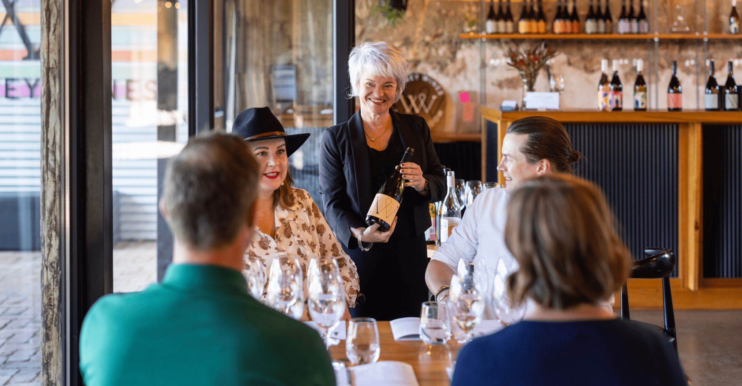 Tasting Room Manager, Kathrin Varney conducting a structured tasting with guests at the Tatsing Room.