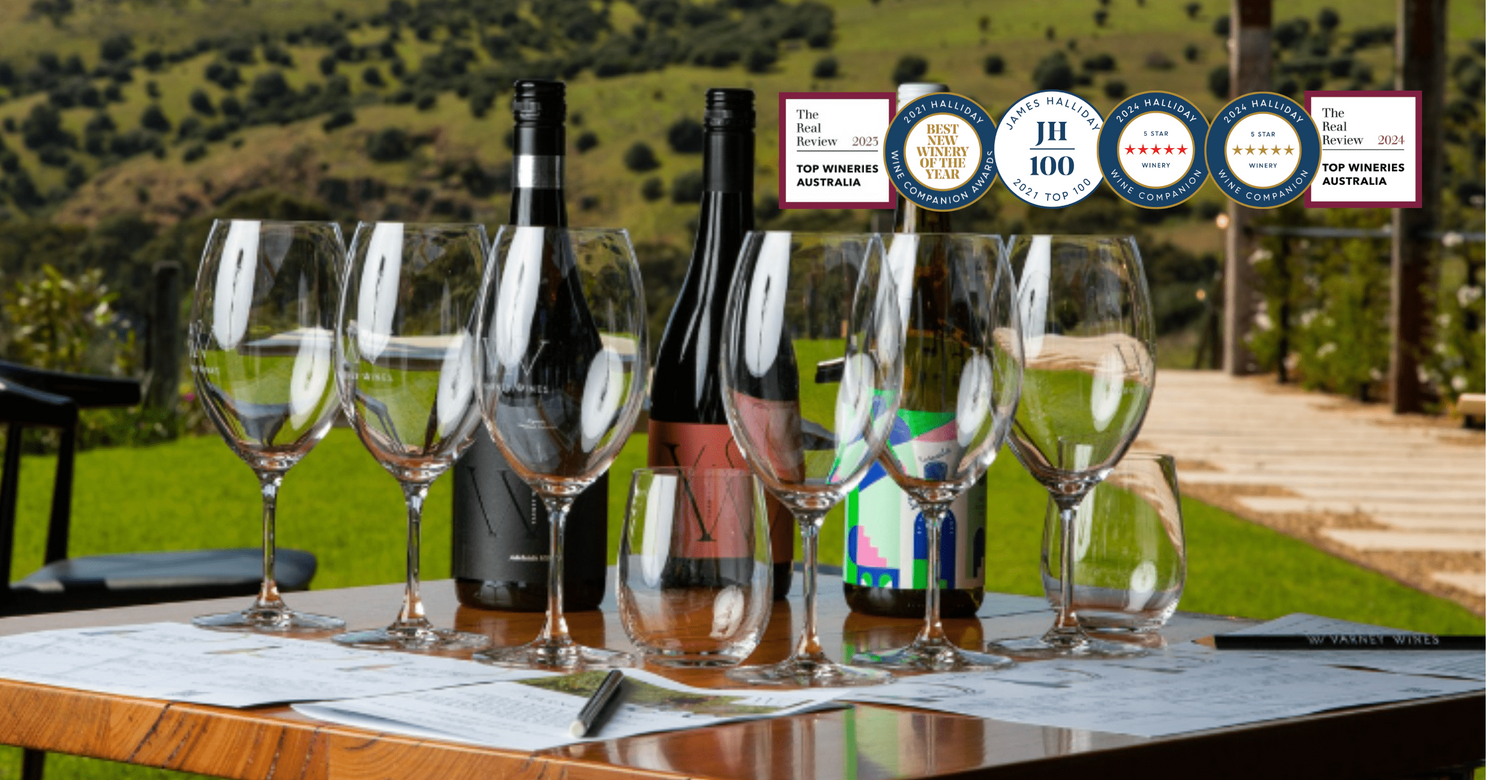 A table set in the Varney Wines Tasting Room. Varney Wines accolades also appear.