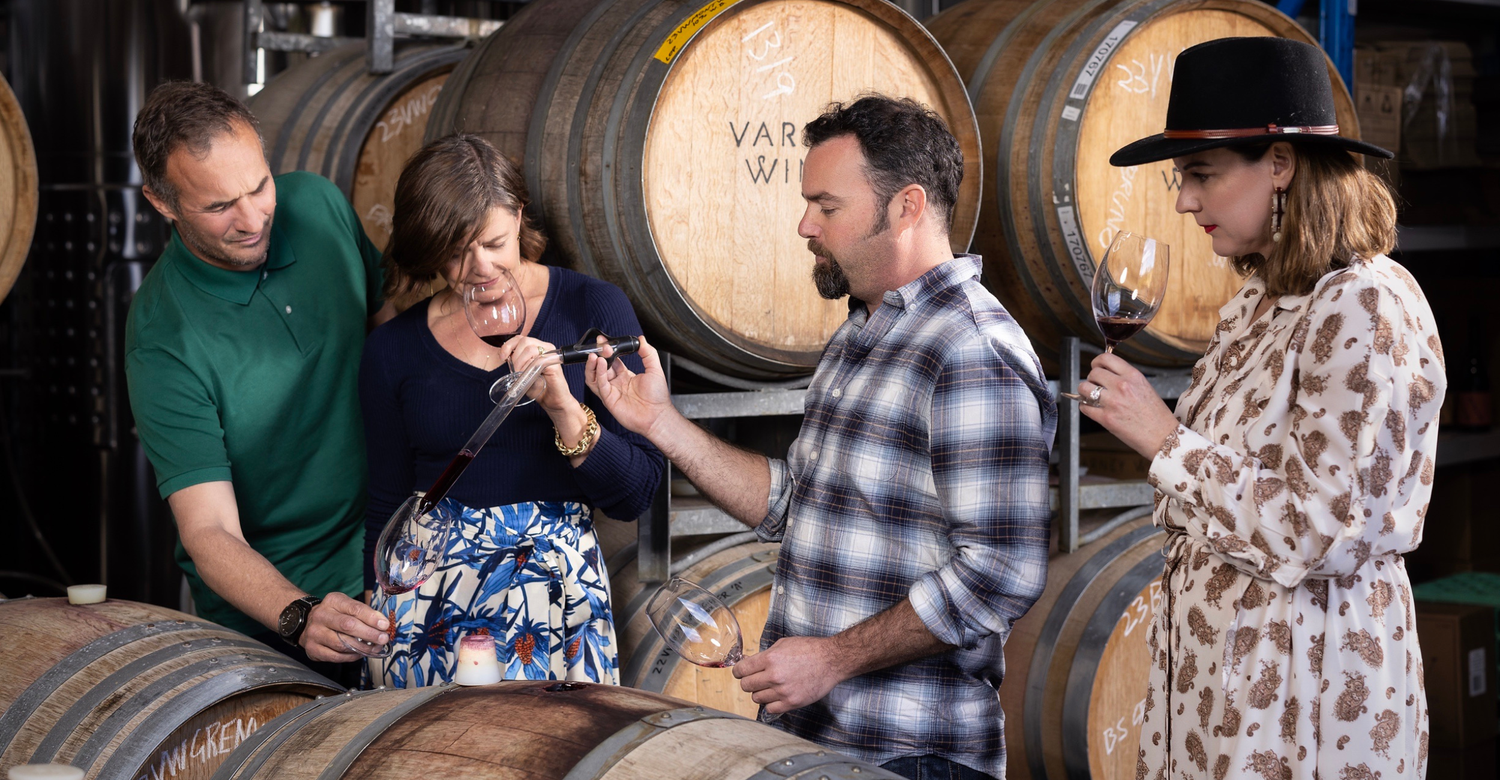 Guests enjoying a barrel tasting in the Varney Wines winery with winemaker, Alan Varney.